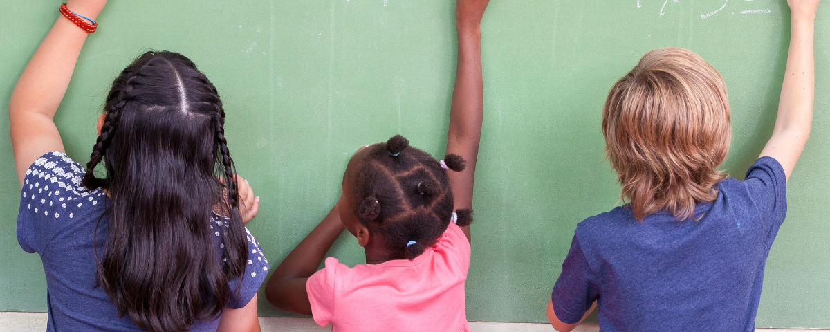 children writing numbers in chalk board