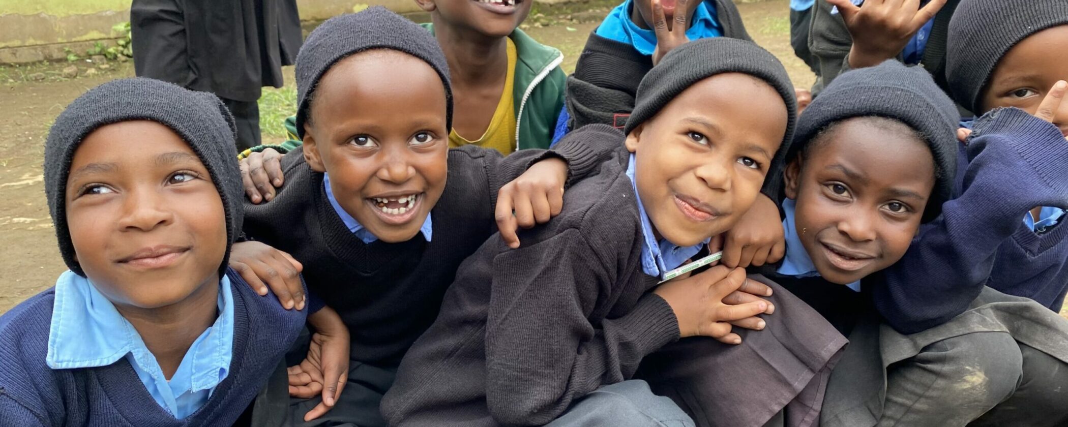 Group of children smiling for the camera.