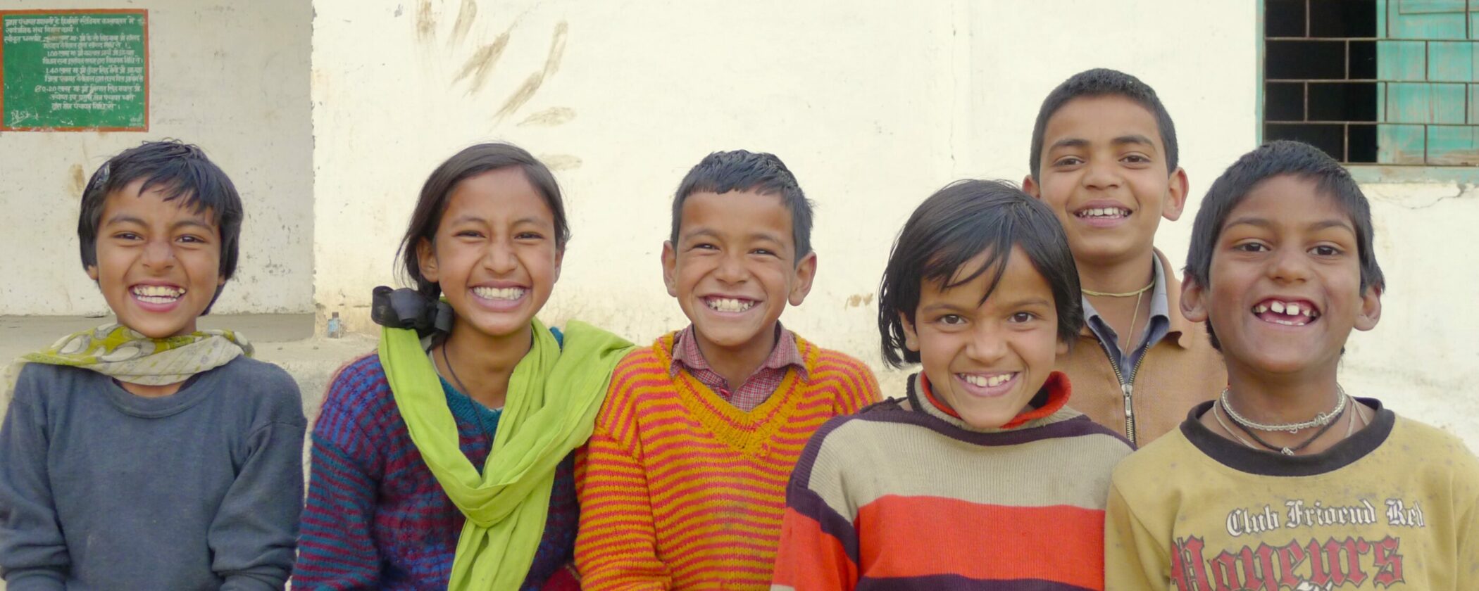 A joyful group of children posing happily for a photograph.