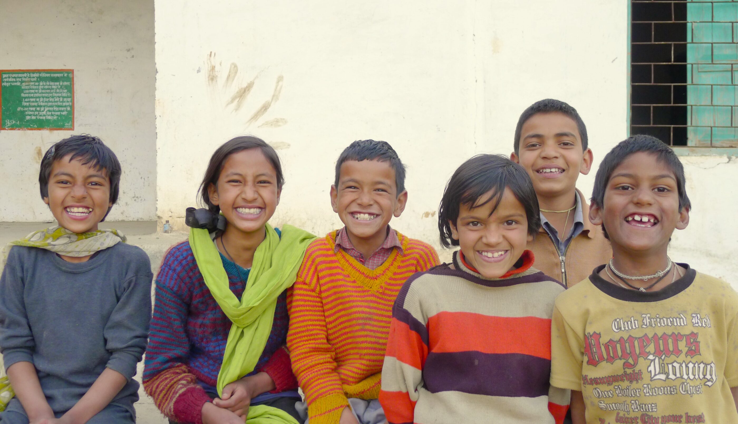 A joyful group of children posing happily for a photograph.