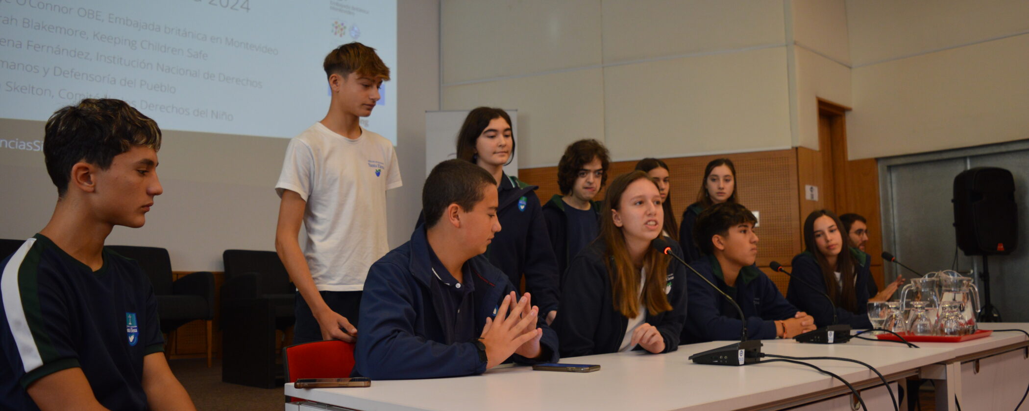 Children sat at a table speaking at the summit.